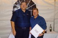 From left to right: Bob Black presenting the award to Chris Guest